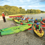school pupils stat on kayaks