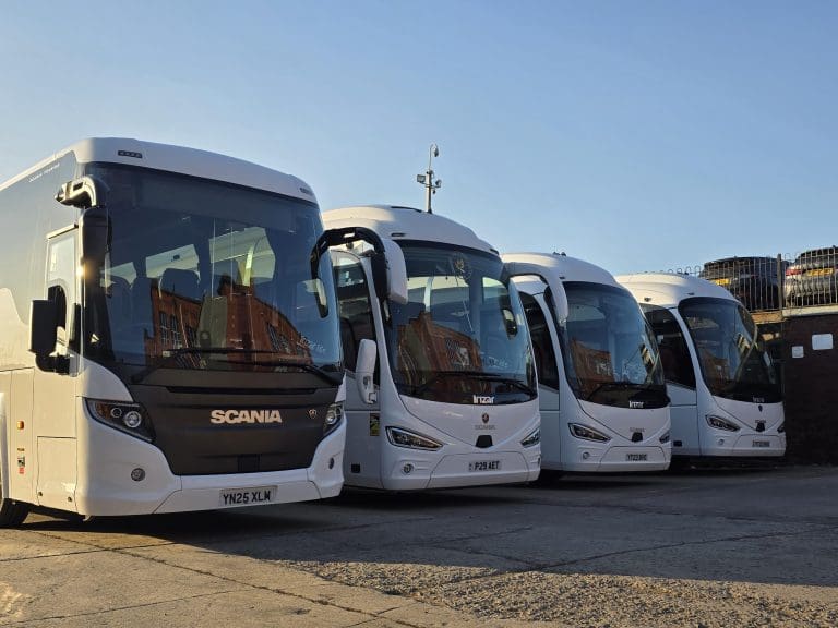 four coaches parked in car park