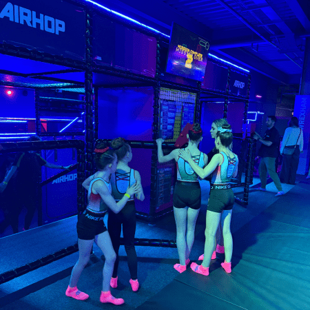 school group at trampoline centre looking at scoreboard