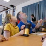 pupils and Xplore science tour guide making lights on a ceiling for a science task