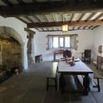 Tudor style kitchen area with table, side table and fireplace