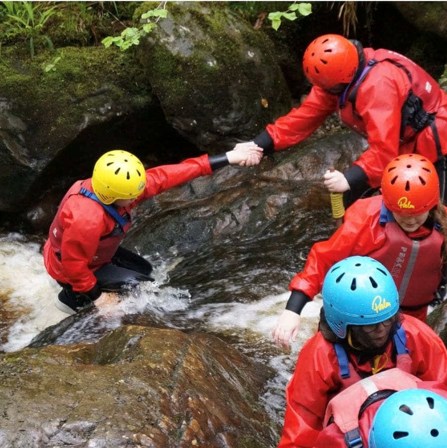 school trip group canyoneering on an outdoor activities adventure
