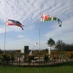 outdoor field with flags and a memorial statue at Bosworth battlefield