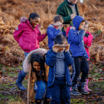 school children outside doing field studies