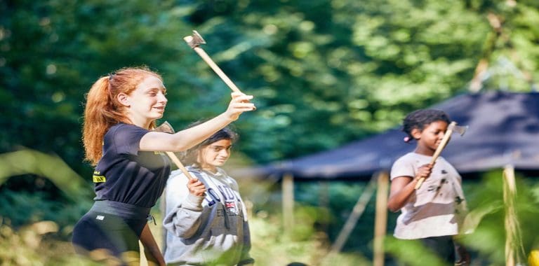 school pupils throwing Axes at large target