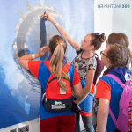 secondary school pupils looking at poster of the i360 observation tower in Brighton