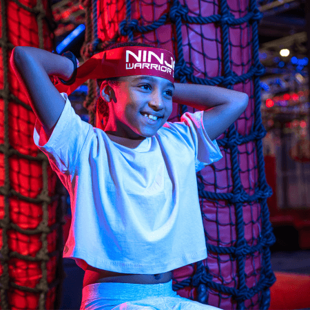 primary school pupil sitting wearing a headband with Ninja warrior written on it