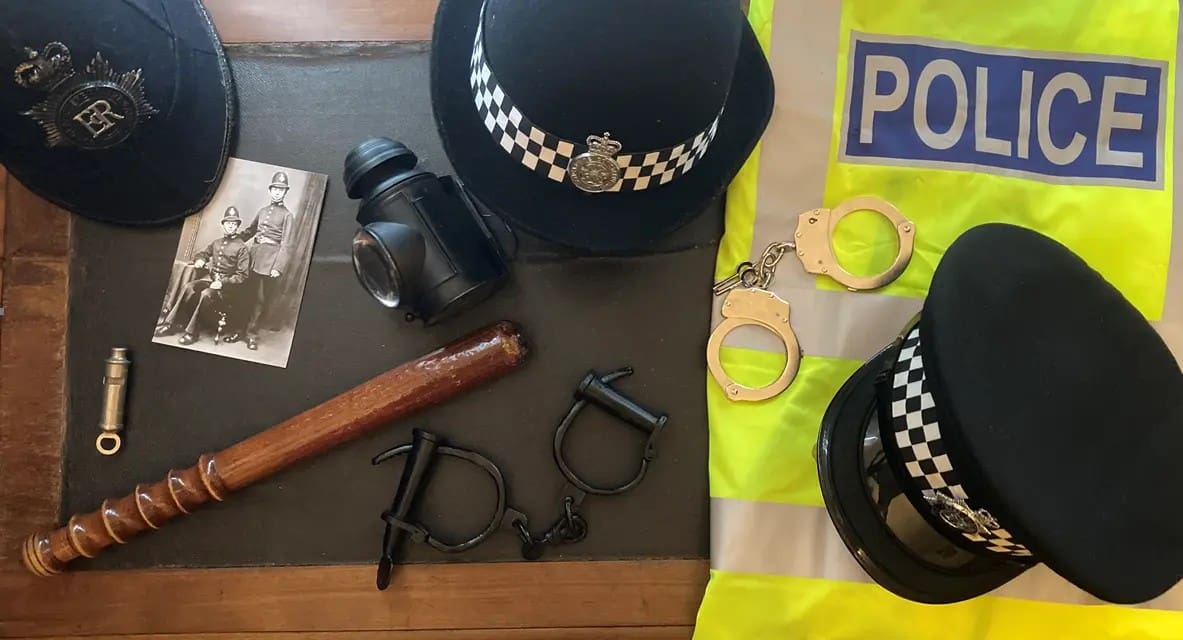 image depicting police hats, whistle, lamp handcuffs and police baton at the national justice museum