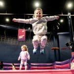 image shows primary school pupil jumping on trampolines