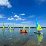 image depicts school group boating on a lake