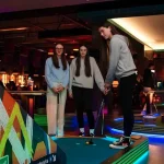 students playing indoor crazy golf
