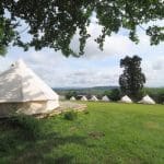 image of bell tents in fields at wilderness centre Forest of Dean