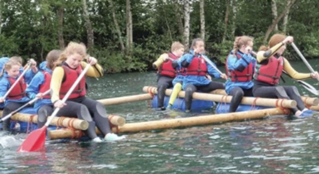 image of pupils doing water sports on rafts at Herts Young Mariners Centre