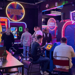 Group of students at gameshow all stars Leeds on arcades