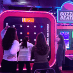 Group of students at gameshow all stars Leeds playing a light reaction game