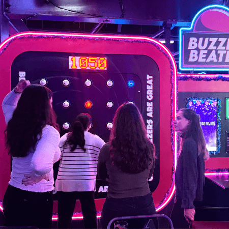 Group of students at gameshow all stars Leeds playing a light reaction game