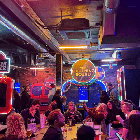 Group of students at gameshow all stars Leeds in a group communicating