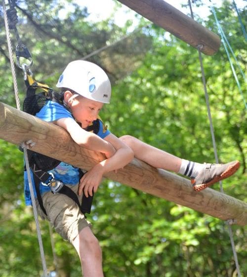 pupil climbing up log tower
