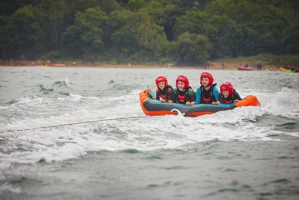 school pupils in lake on a inflatable raft