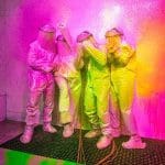 school group getting covered in pink spray paint at an interactive immersive activity centre
