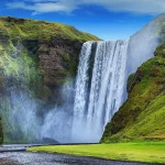 waterfall flowing into a river in the countryside