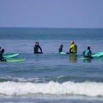 school pupil in the sea on surf boards