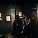 students in museum area looking at interactive activities