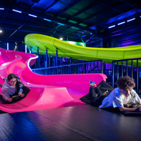 school pupils at an indoor slide action park