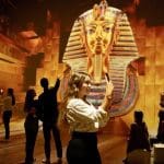students taking photos of an exhibition of the Great Sphinx