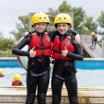 two school pupils doing water activities in a pool