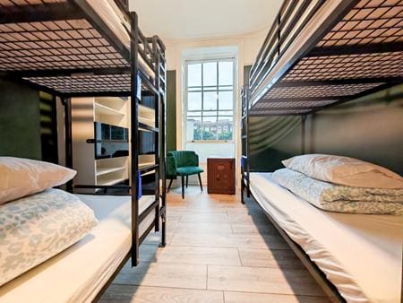 indoor hostel room with multiple bunkbeds