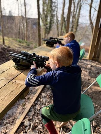 school pupil shooting a pellet pistol on a gun range