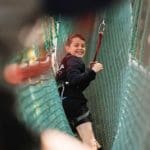 school pupil on a net high ropes course