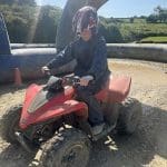 pupil on a quad bike on a dirt track in the countryside