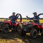 students on off road buggies in a field
