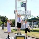 pupils on a winners podium outside at a museum