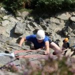 school pupil doing rock climbing