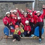school group in wet suits having a group photo