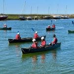 pupils on a river in canoe paddling