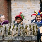 pupils with funny Tudor hats and jester clothes