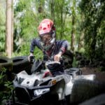school pupil on a Quad bike in the forest