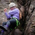 School pupil abseiling down cliff