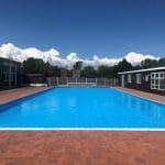 external drone shot of an outdoor swimming pool