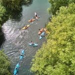 school group in kayaks on river in Harlow