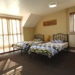 bunkroom with beds and side table