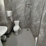 bathroom with toilet, sink and shower