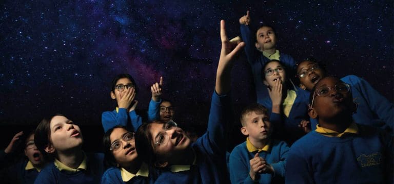school pupils in an interactive 3 d viewing room showing the universe and space