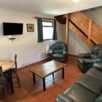 indoor social area with sofa and arm chairs for groups to relax