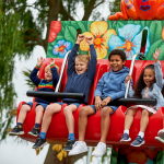 primary school pupils on a school trip on a themed ride