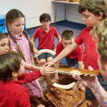 primary school pupils looking at animal bones